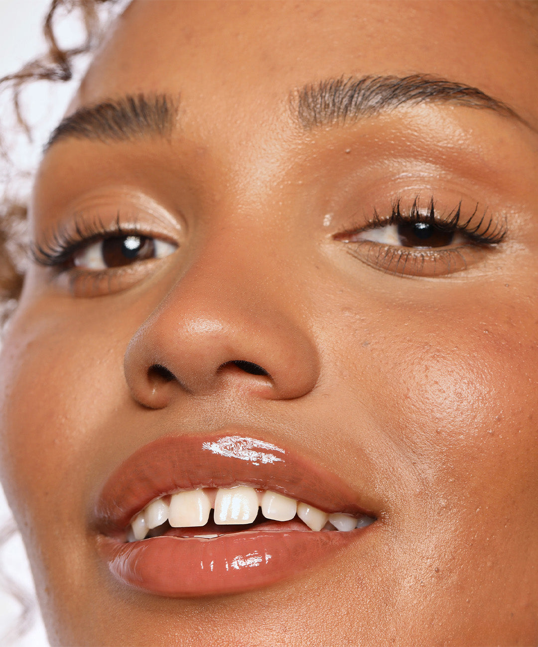 | desc: Model wears Lip Gloss in shade Taupe