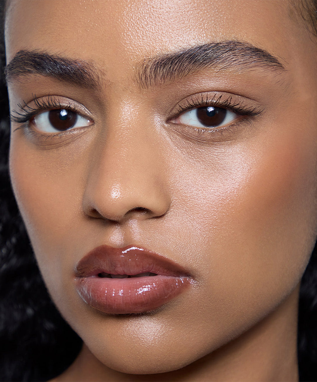 | desc: Manar wears Lip Gloss in shade Suede