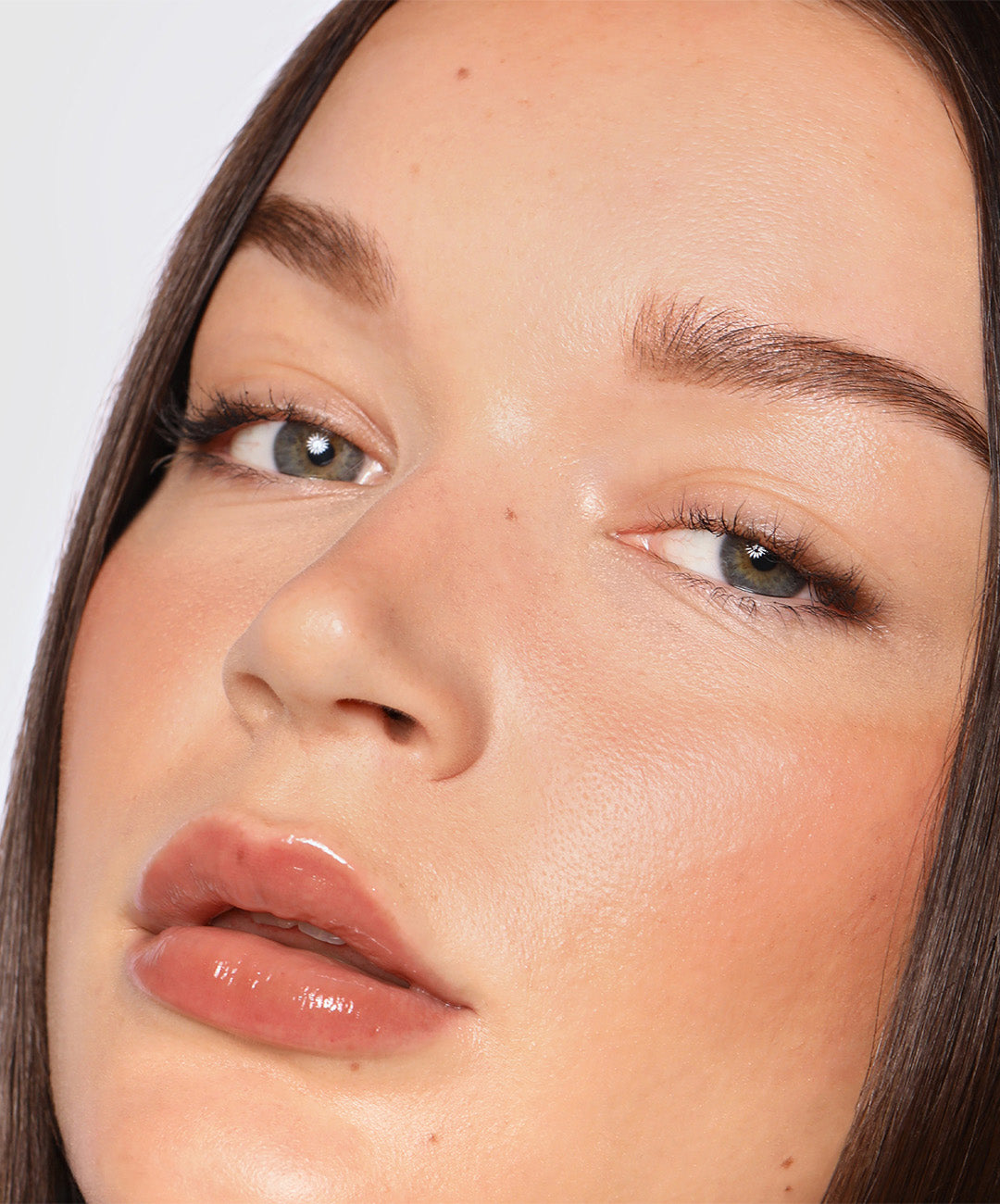 | desc: Model wears Lip Gloss in shade Taupe