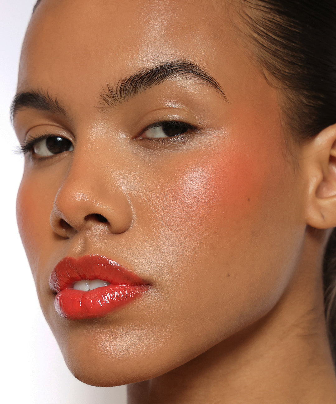 | desc: Model wears Lip Gloss in shade Papaya