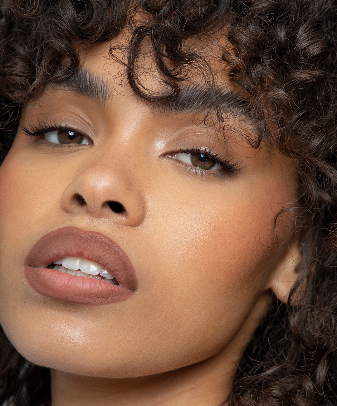 | desc: Model wears Lip Sculpt in shade Fawn