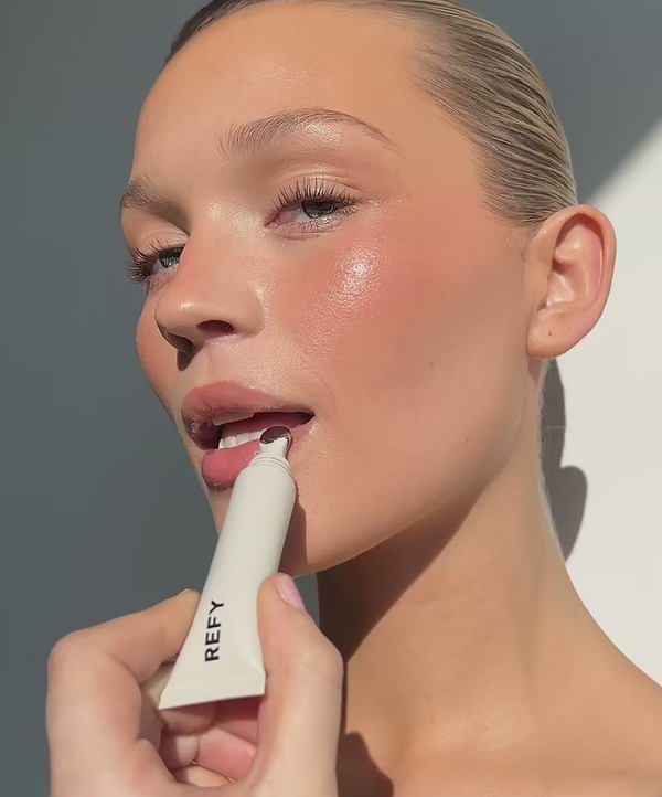 video of model applying REFY lip gloss in the shade topaz