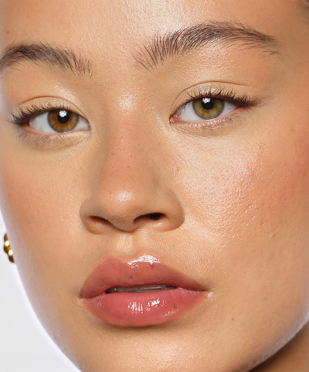 | desc: Model wears Lip Gloss in shade Rosewood