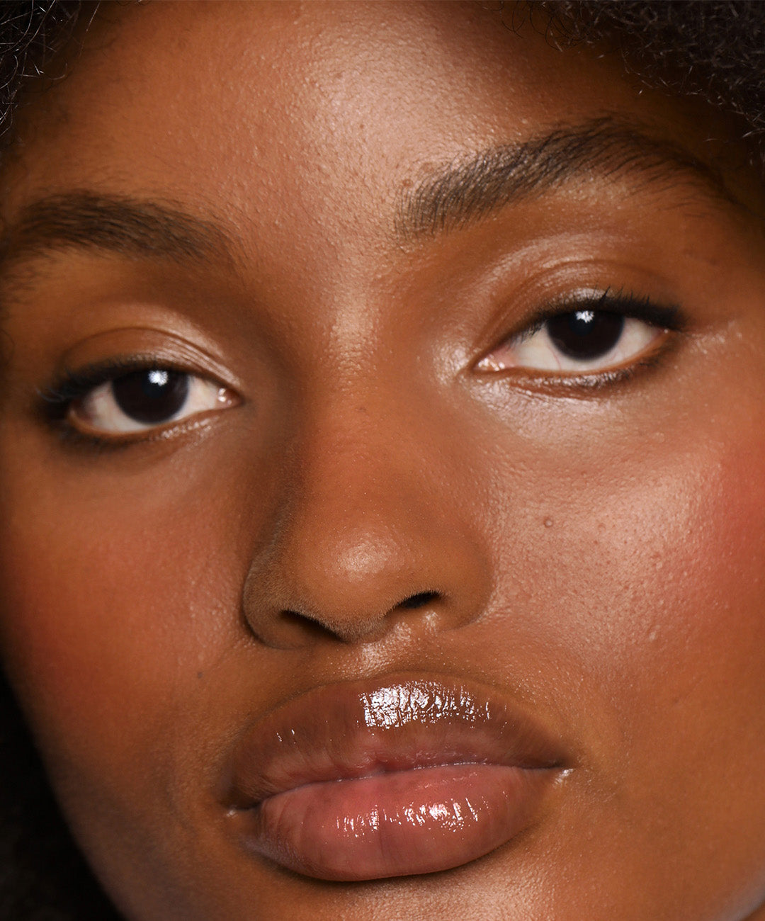 | desc: Model wears Lip Gloss in shade Sepia