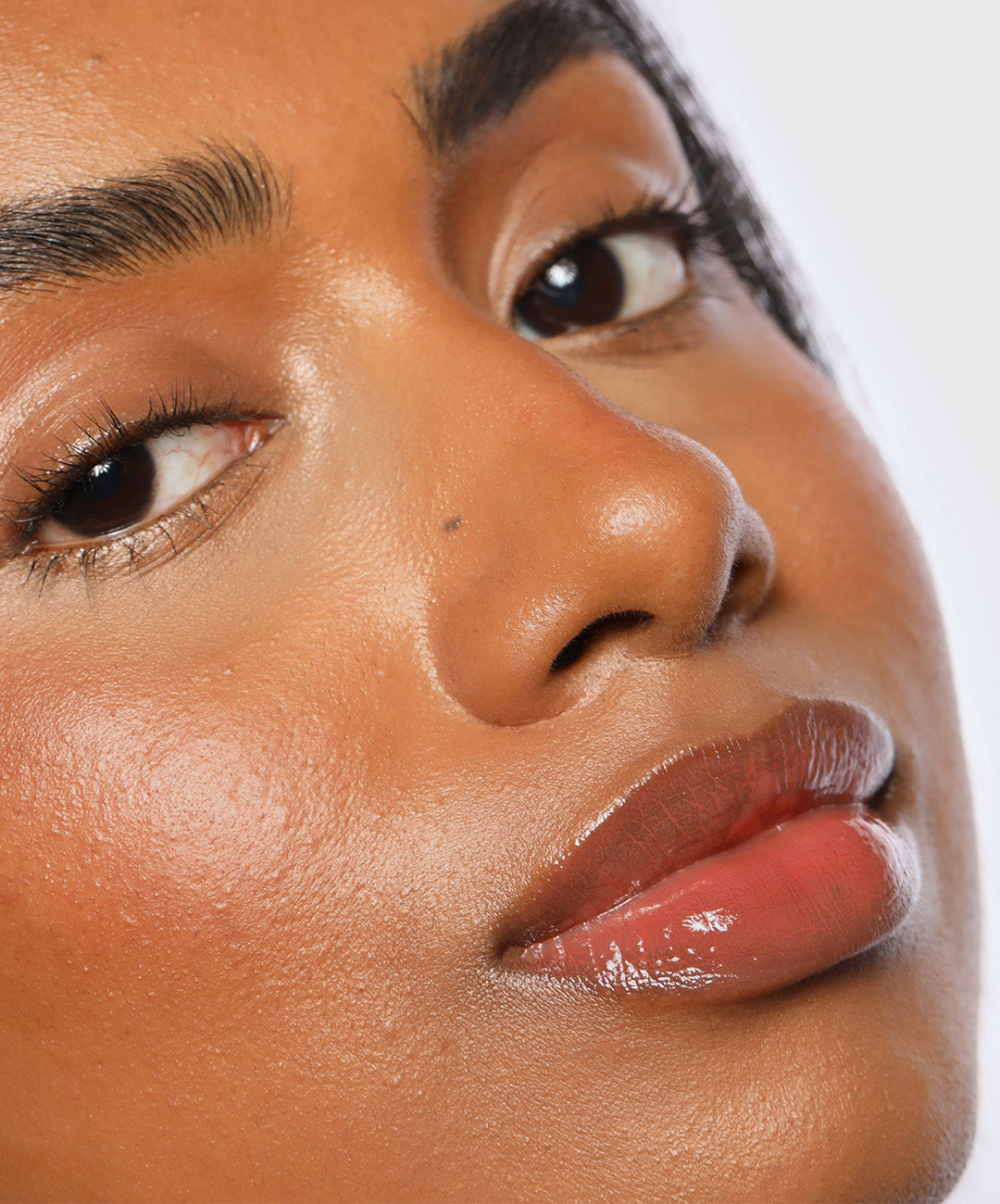 | desc: Model wears Lip Gloss in shade Dusk