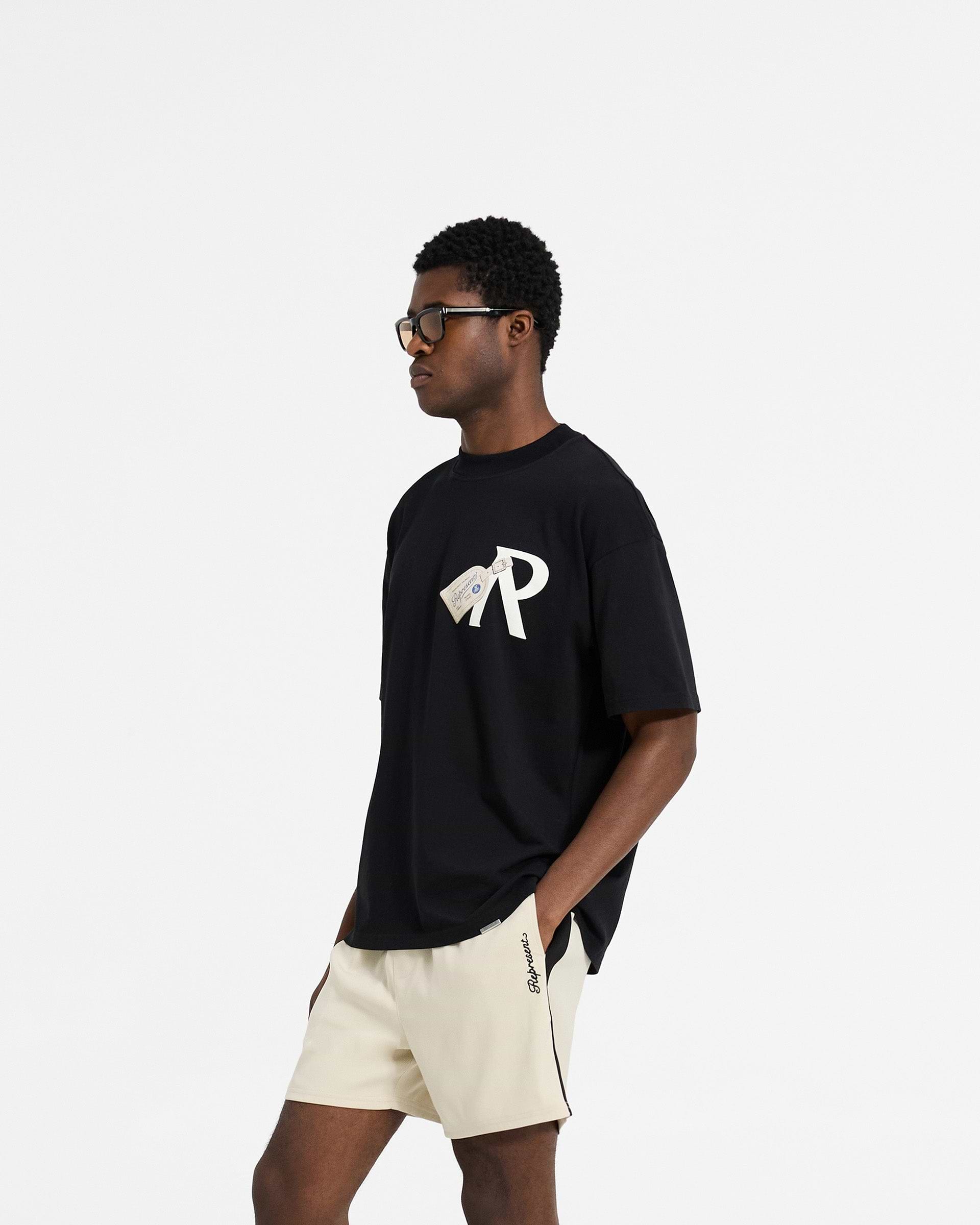 Luggage Tag T-Shirt | Jet Black | REPRESENT