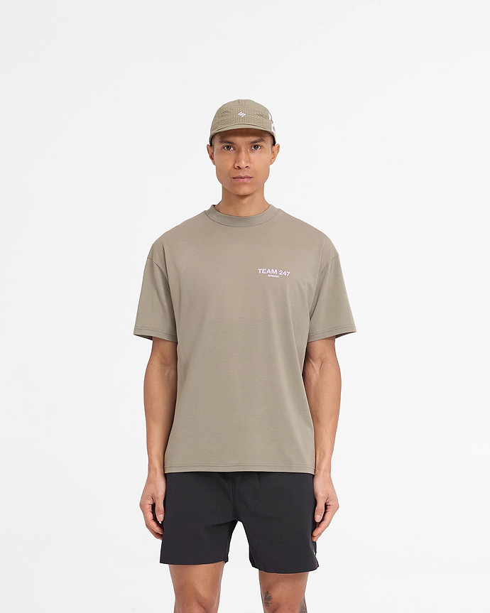 Man wearing an oversized khaki t-shirt with lilac accents on a plain white background | Team 247 Oversized T-Shirt in Khaki Lilac | Quick drying lightweight t-shirt | 247 T-Shirts | Represent Clo