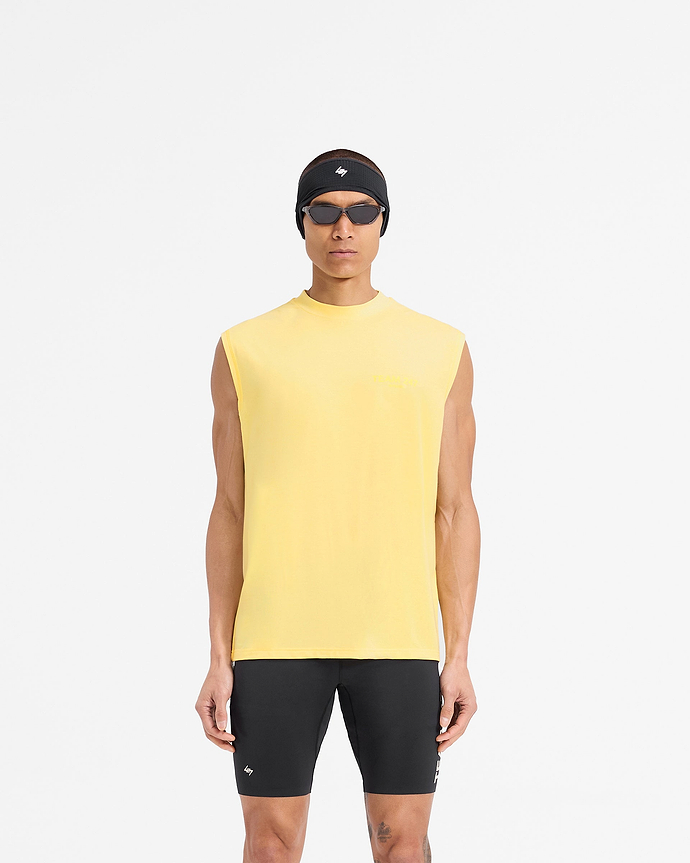 Man wearing an oversized yellow tank top on a plain white background | Team 247 Oversized Tank in Lemon | Lightweight quick-drying training tank | 247 T-Shirts | Represent Clo
