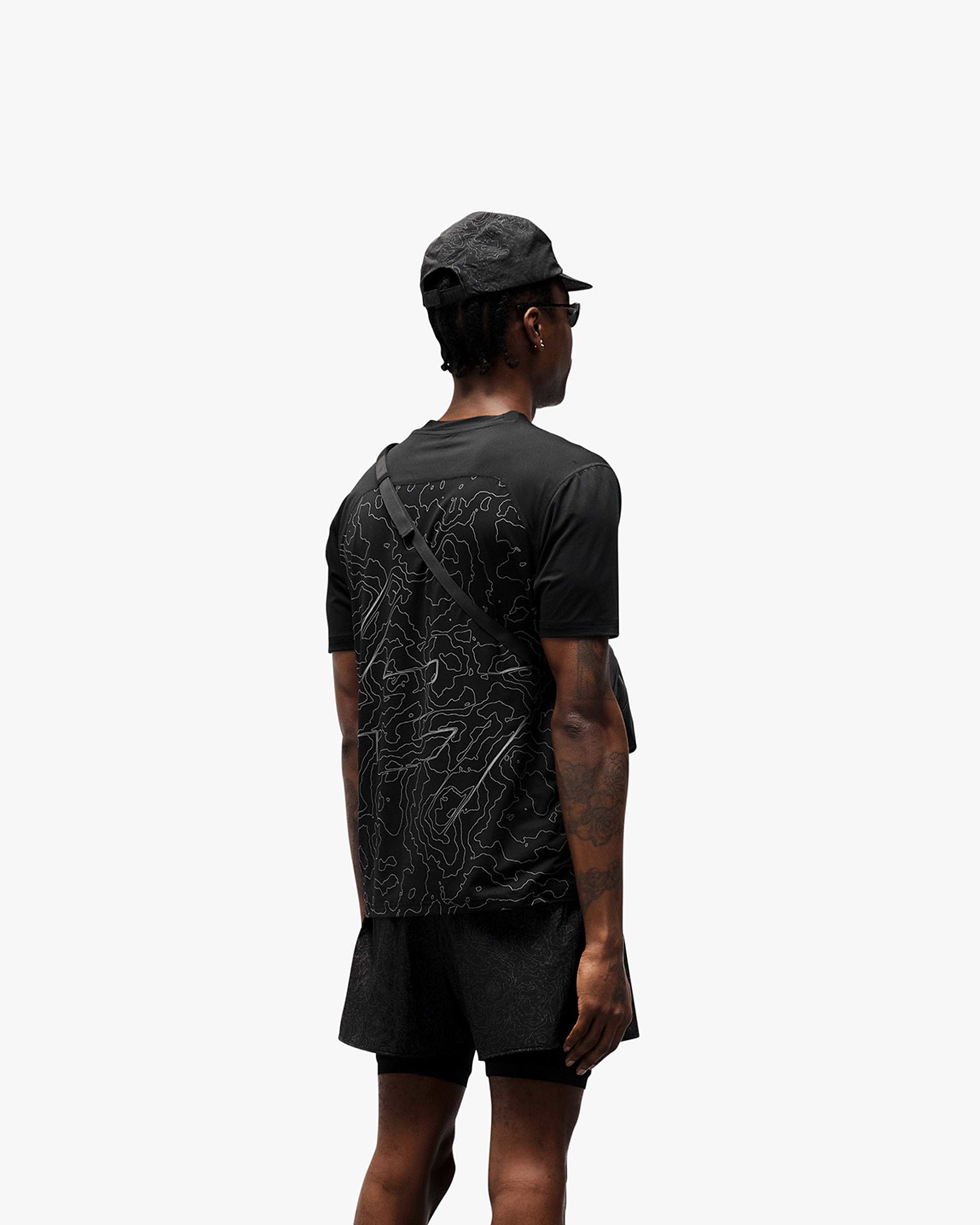 Man wearing a black running t-shirt on a plain white background | 247 Contour Run T-Shirt in Black | Breathable mesh running t-shirt with reflective contour print | 247 T-Shirts | Represent Clo