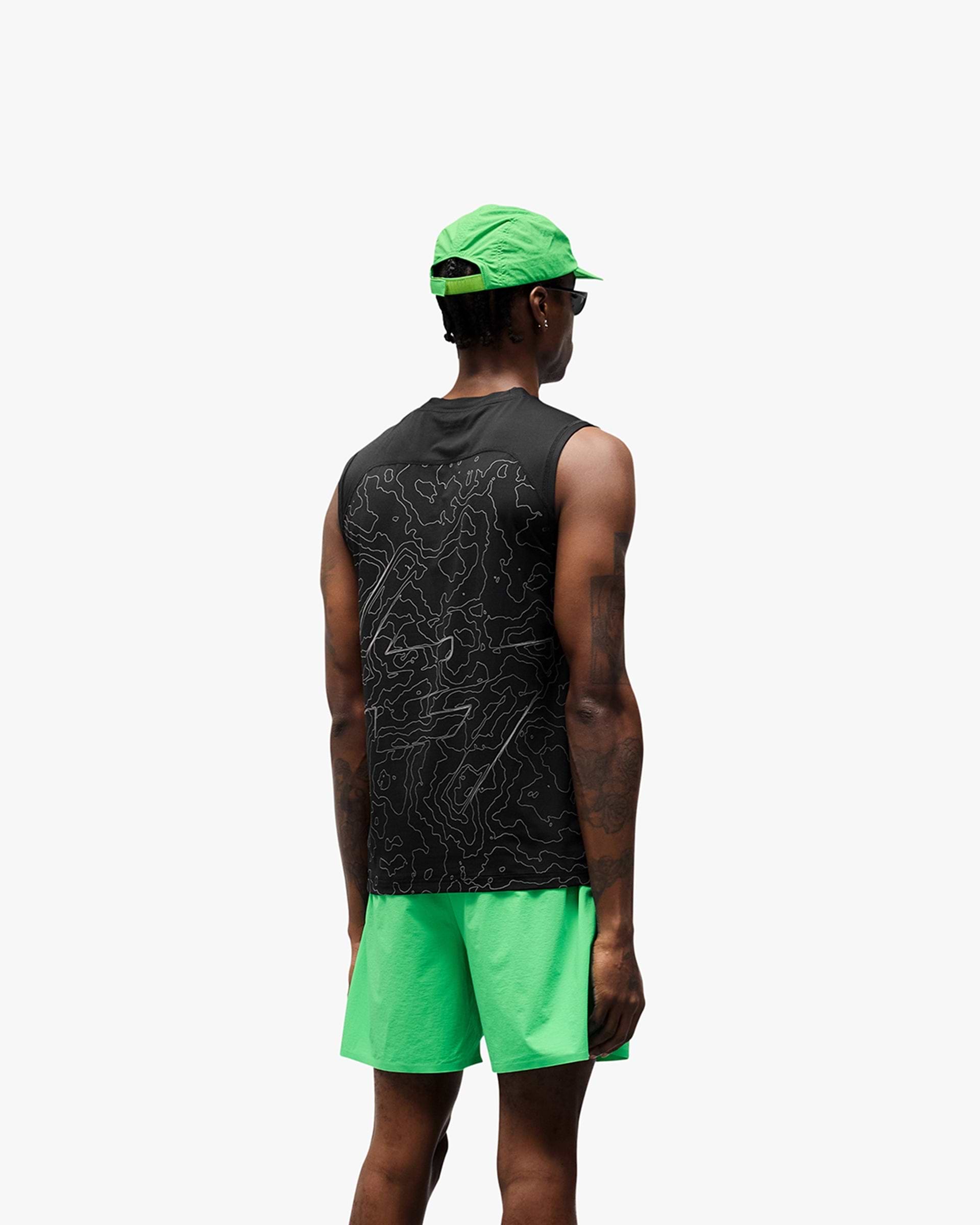 Man wearing a black running tank on a plain white background | 247 Contour Run Tank in Black | Breathable mesh running tank with reflective print | 247 T-Shirts | Represent Clo