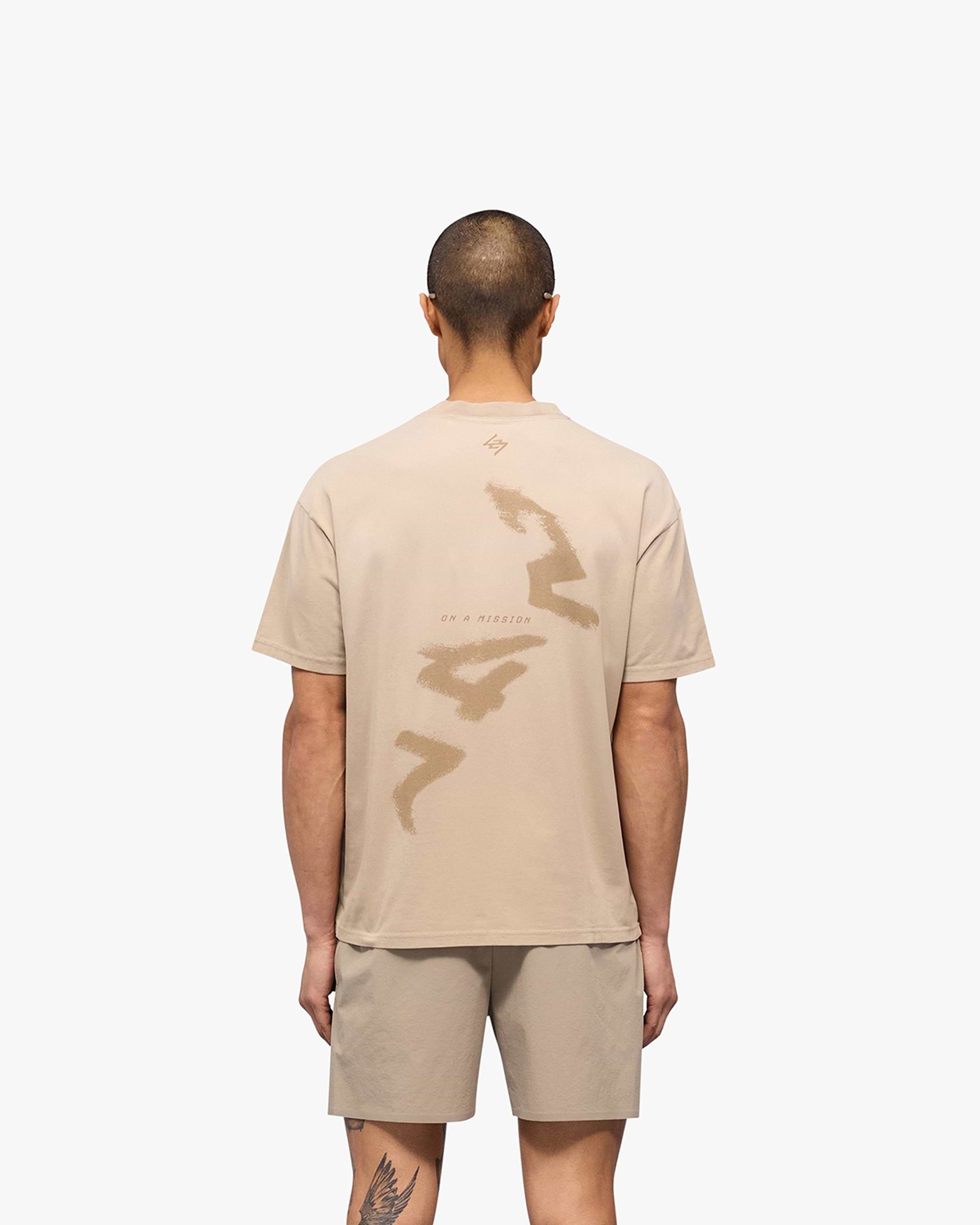 Man wearing an oversized grey t-shirt on a plain white background | 247 Motion Oversized T-Shirt in Pebble | Oversized t-shirt with sweat wicking and 2 way stretch | 247 T-Shirts | Represent Clo