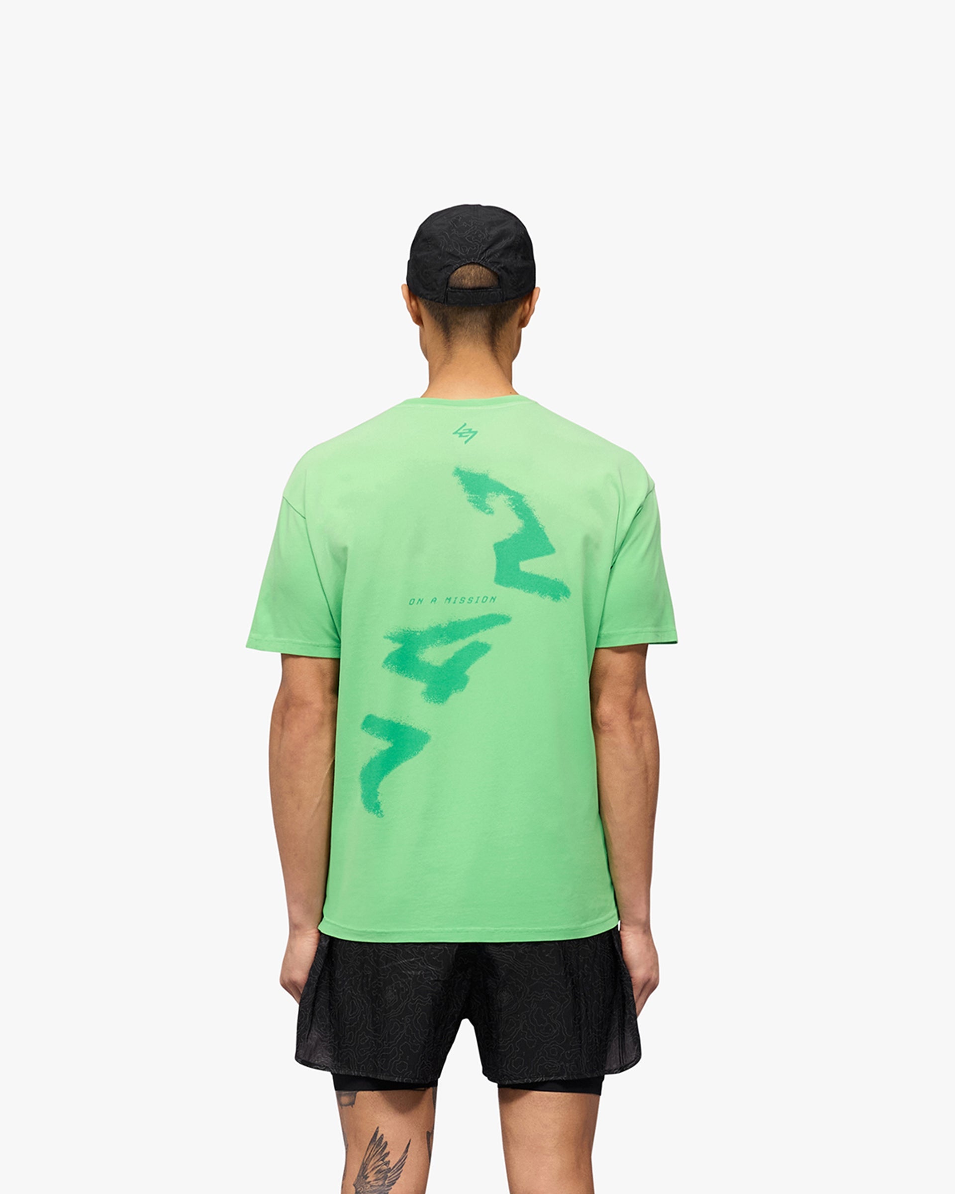 Man wearing an oversized green t-shirt on a plain white background | 247 Motion Oversized T-Shirt in Speed Green | Oversized t-shirt with water based graphic print | 247 T-Shirts | Represent Clo