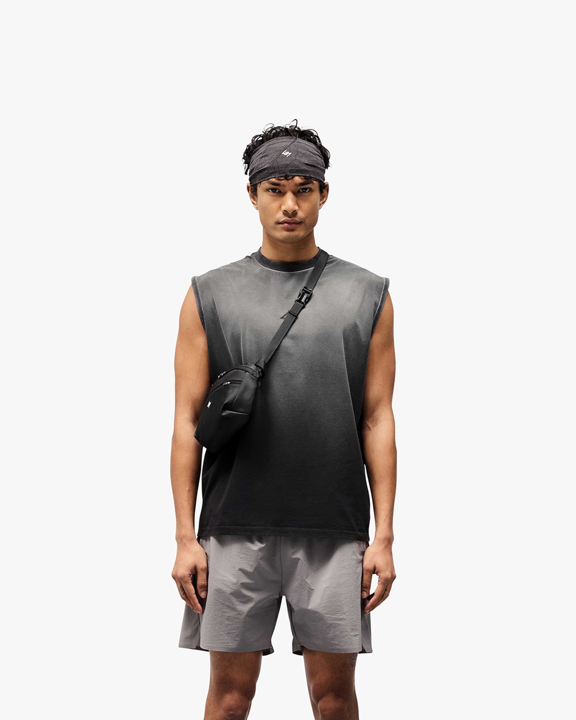 Man wearing a black oversized tank top on a plain white background | 247 Motion Oversized Tank in Aged Black | Oversized tank with 2 way stretch and vintage wash | 247 T-Shirts | Represent Clo