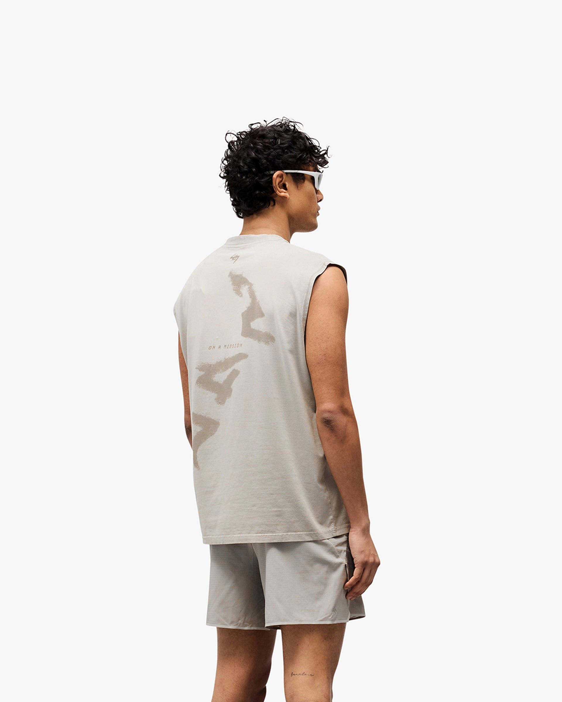 Man wearing an oversized grey tank on a plain white background | 247 Motion Oversized Tank in Pebble | Oversized tank with sweat wicking and antibacterial properties | 247 T-Shirts | Represent Clo