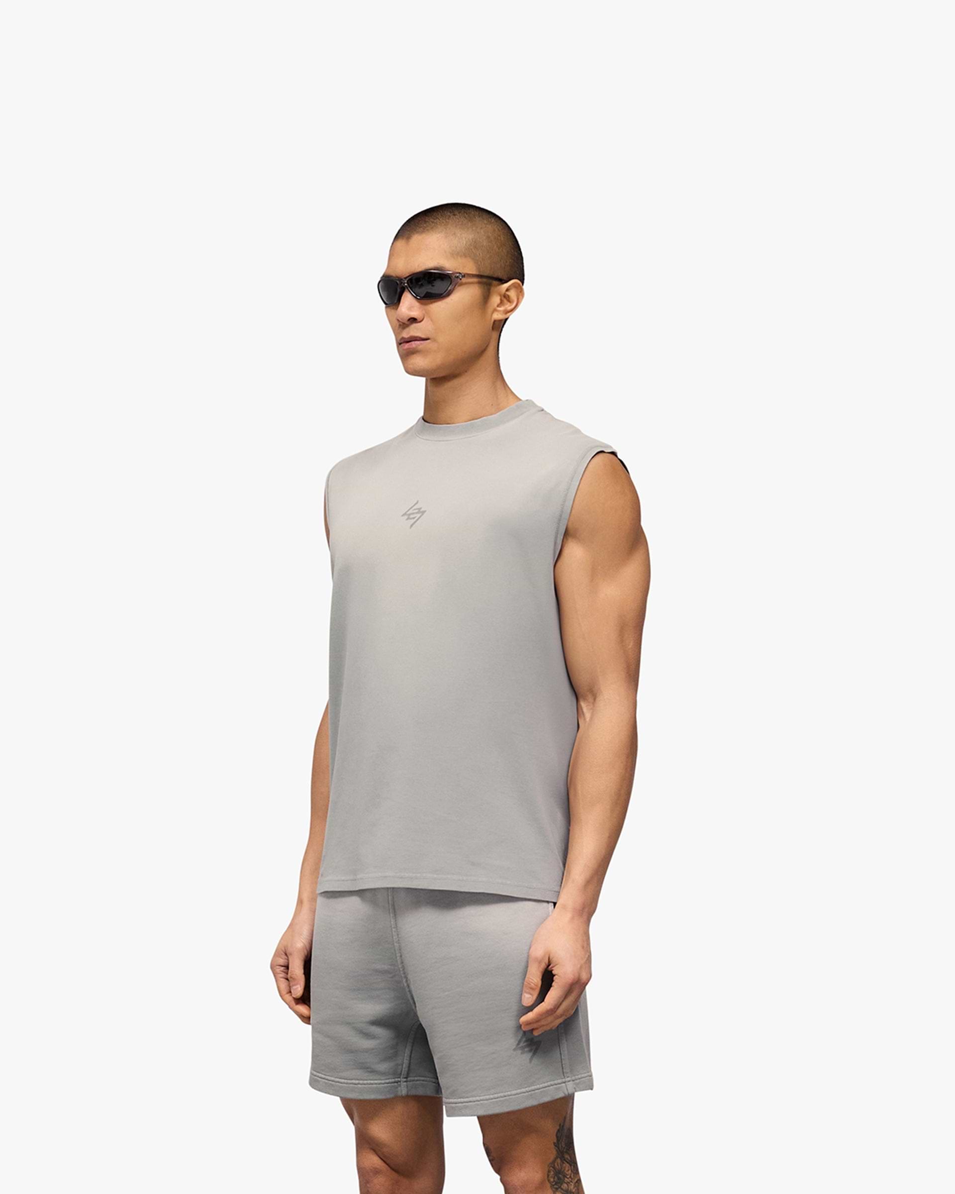 Man wearing an oversized grey tank on a plain white background | 247 Motion Oversized Tank in Titanium | Oversized tank with sweat wicking capabilities | 247 T-Shirts | Represent Clo