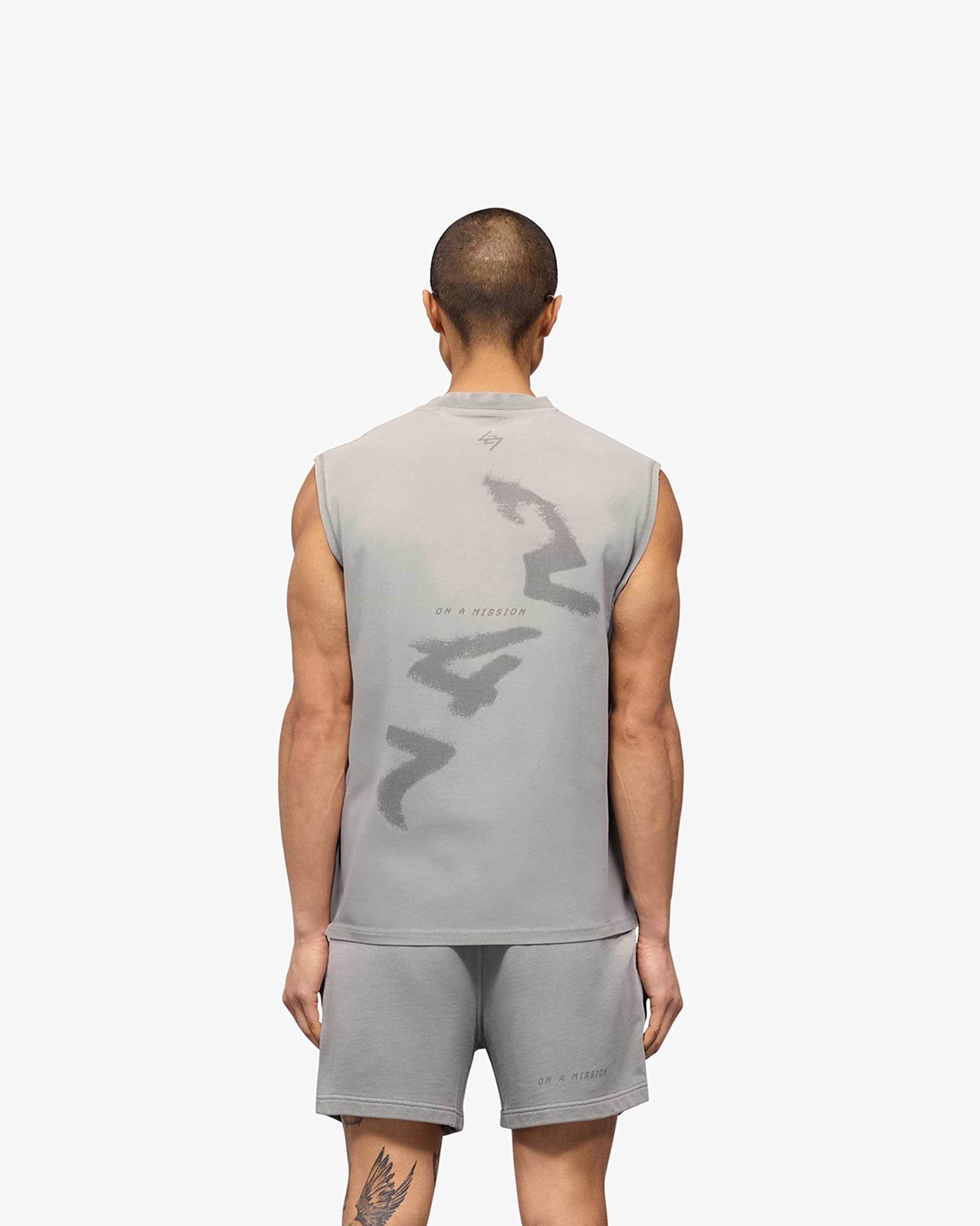 Man wearing a grey oversized tank top on a plain white background | 247 Motion Oversized Tank in Titanium | Oversized tank with sweat wicking and antibacterial properties | 247 T-Shirts | Represent Clo