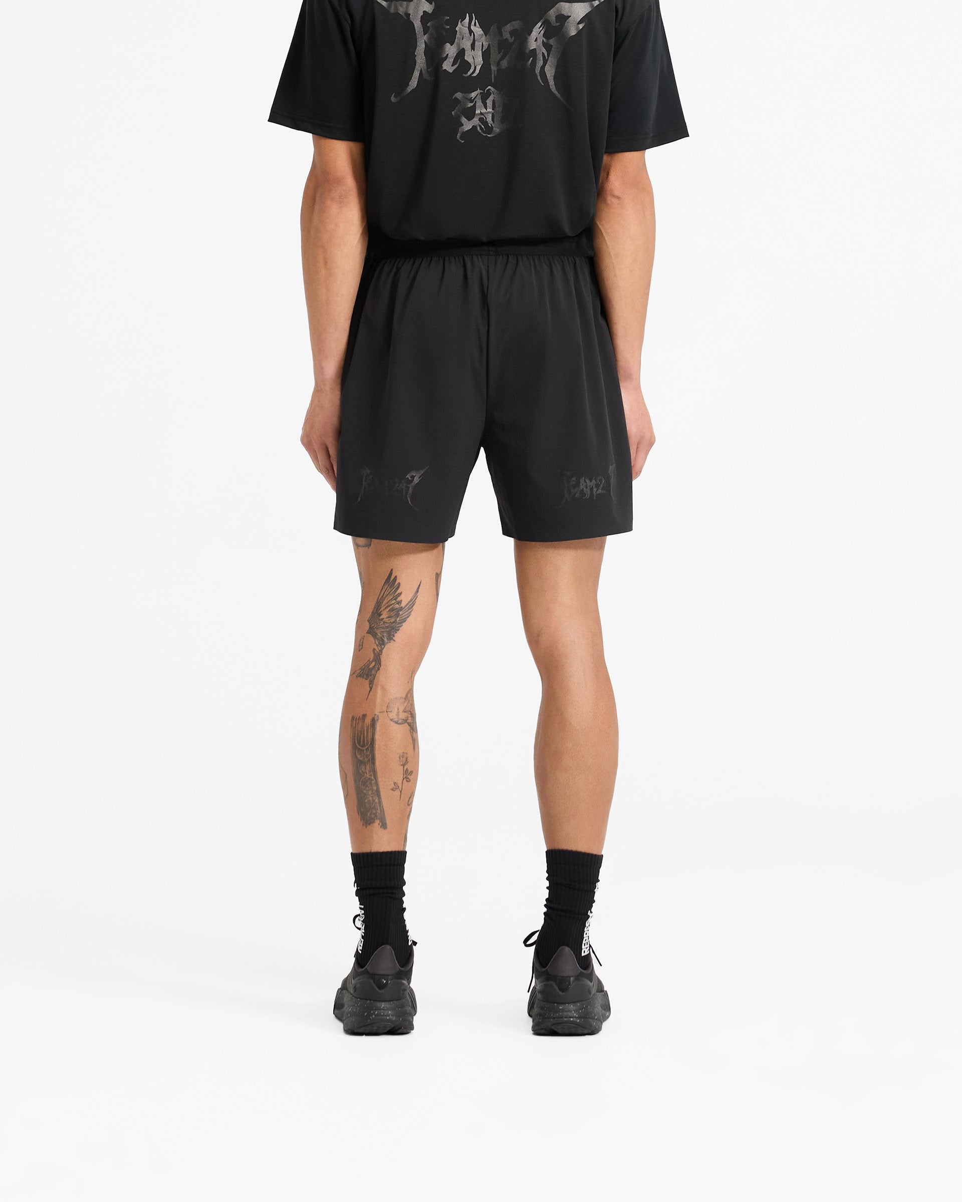 Man wearing black shorts on a plain white background | Team 247 X END Fused Short in Jet Black | Shorts with 4-way stretch and quick-drying fabric | 247 Shorts | Represent Clo