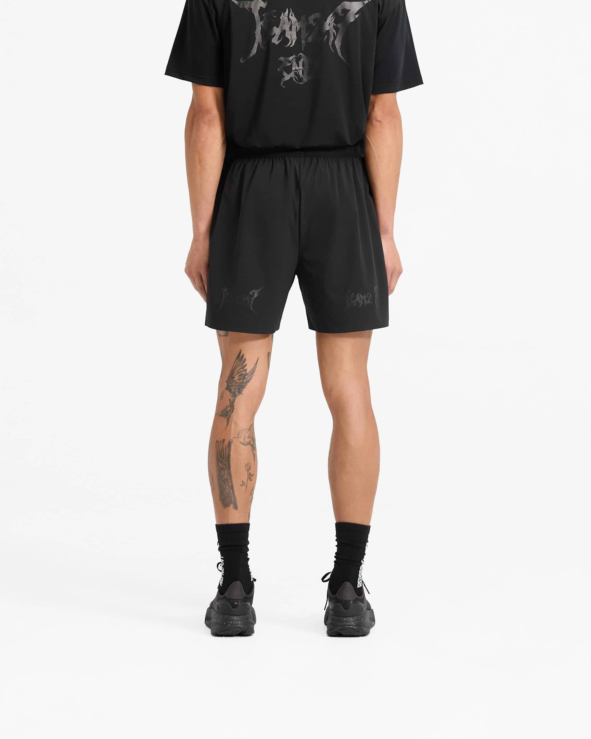 Man wearing black shorts on a plain white background | Team 247 X END Fused Short in Jet Black | Shorts with 4-way stretch and quick-drying fabric | 247 Shorts | Represent Clo