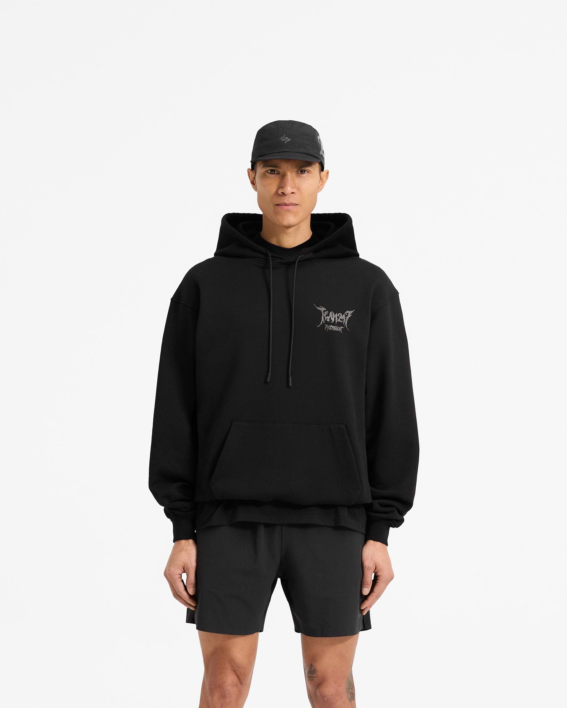 Man wearing an oversized black hoodie on a plain white background | Team 247 X END Oversized Hoodie in Jet Black | Heavyweight hoodie with co-branded graphics and ribbed trims | 247 Hoodies | Represent Clo