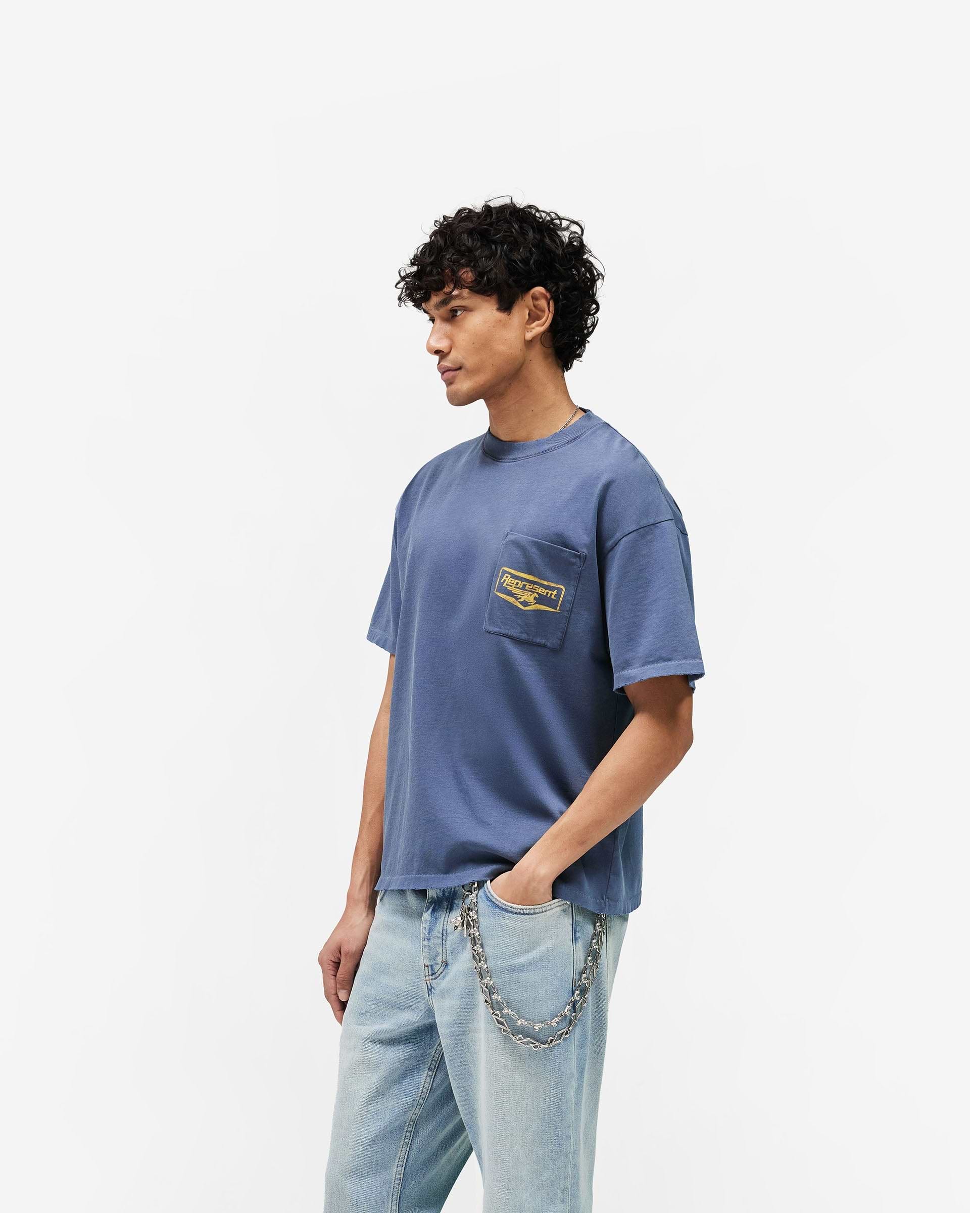 Represent Nothing Faster T-Shirt in Indigo, featuring a chest patch pocket and standard oversized fit.