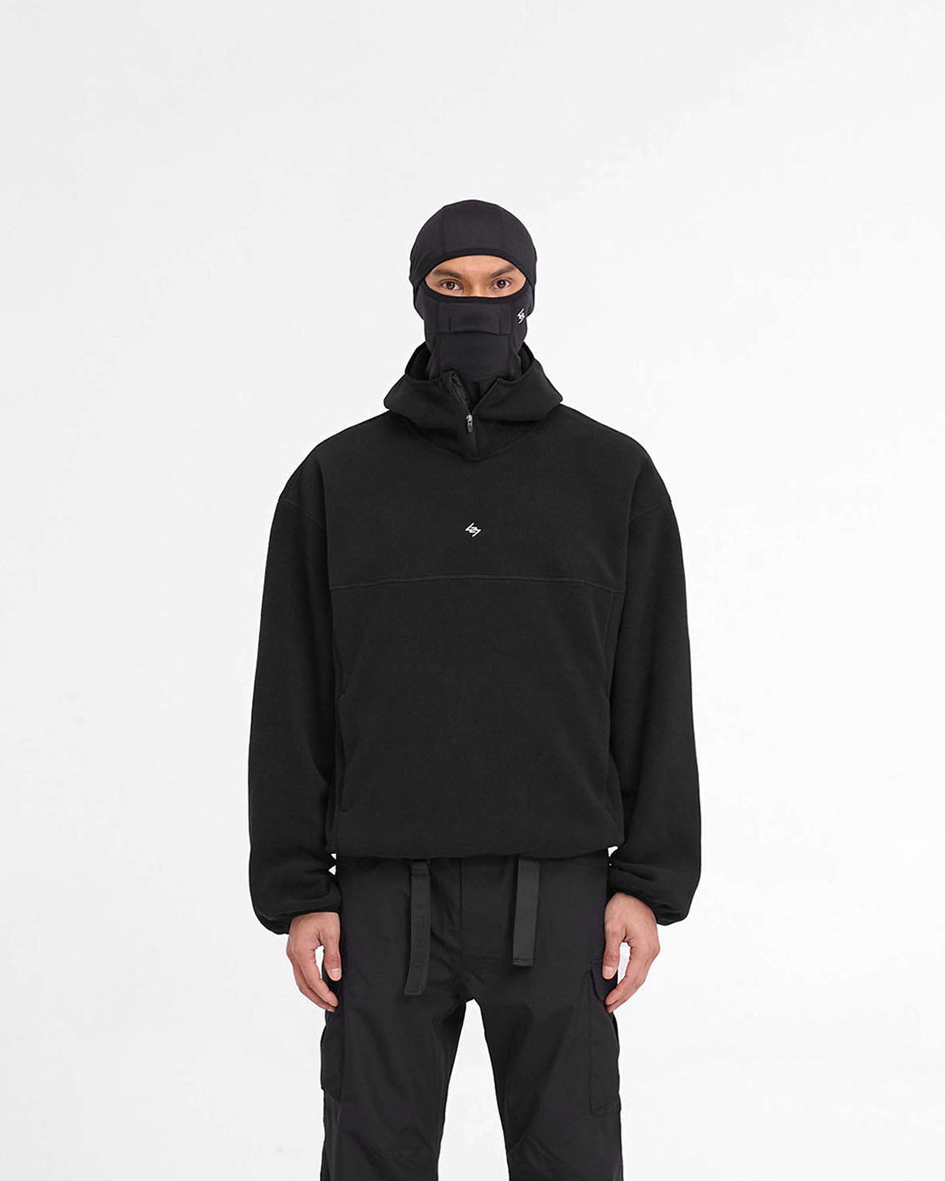 Man wearing a black fleece hoodie on a plain white background | 247 Fleece Hoodie in Black | Oversized fleece hoodie with high chin guard and zip pockets | 247 Hoodies | Represent Clo