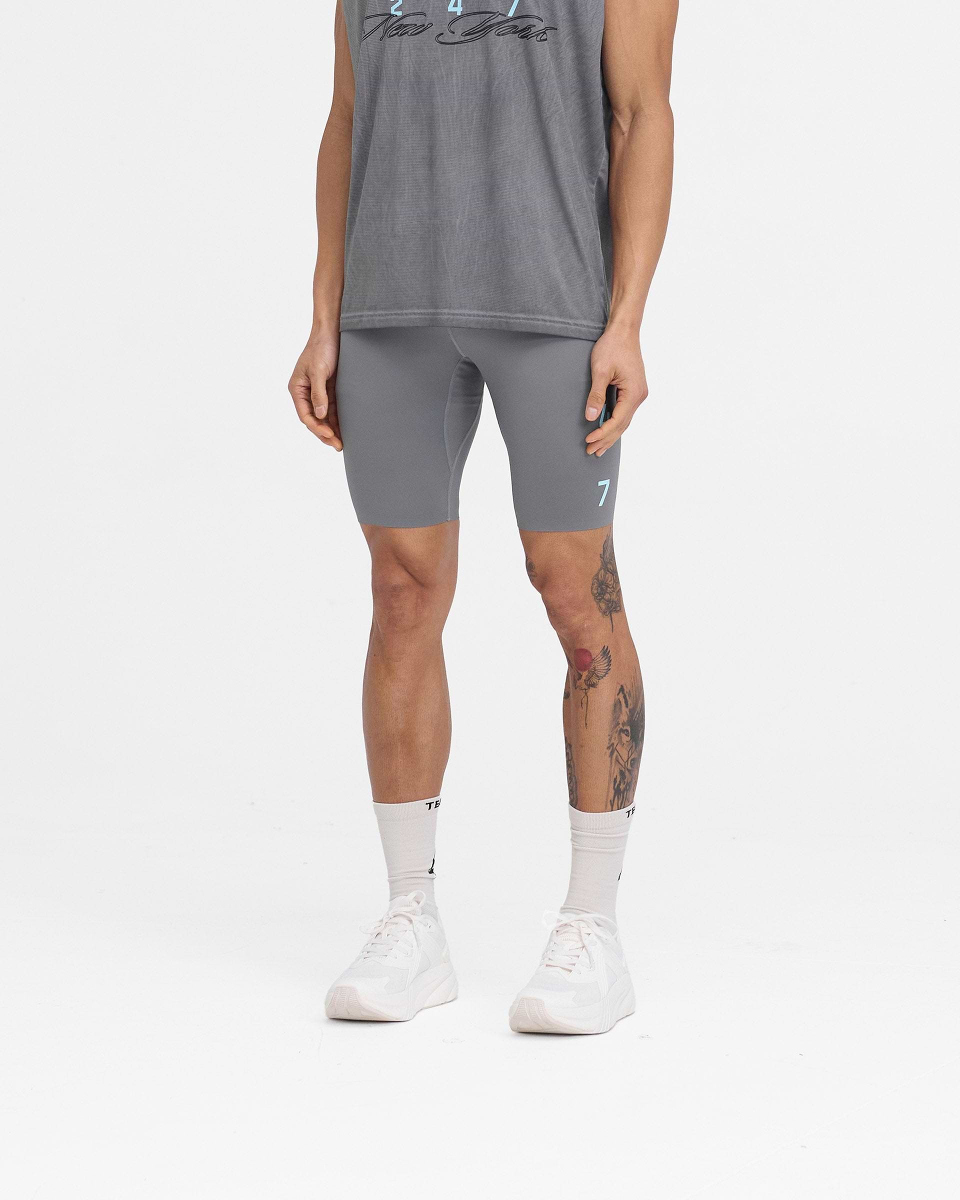 Man wearing grey half tights on a plain white background | 247 New York Half Tight in Smoke | Running half tights with 4-way stretch | 247 Shorts | Represent Clo