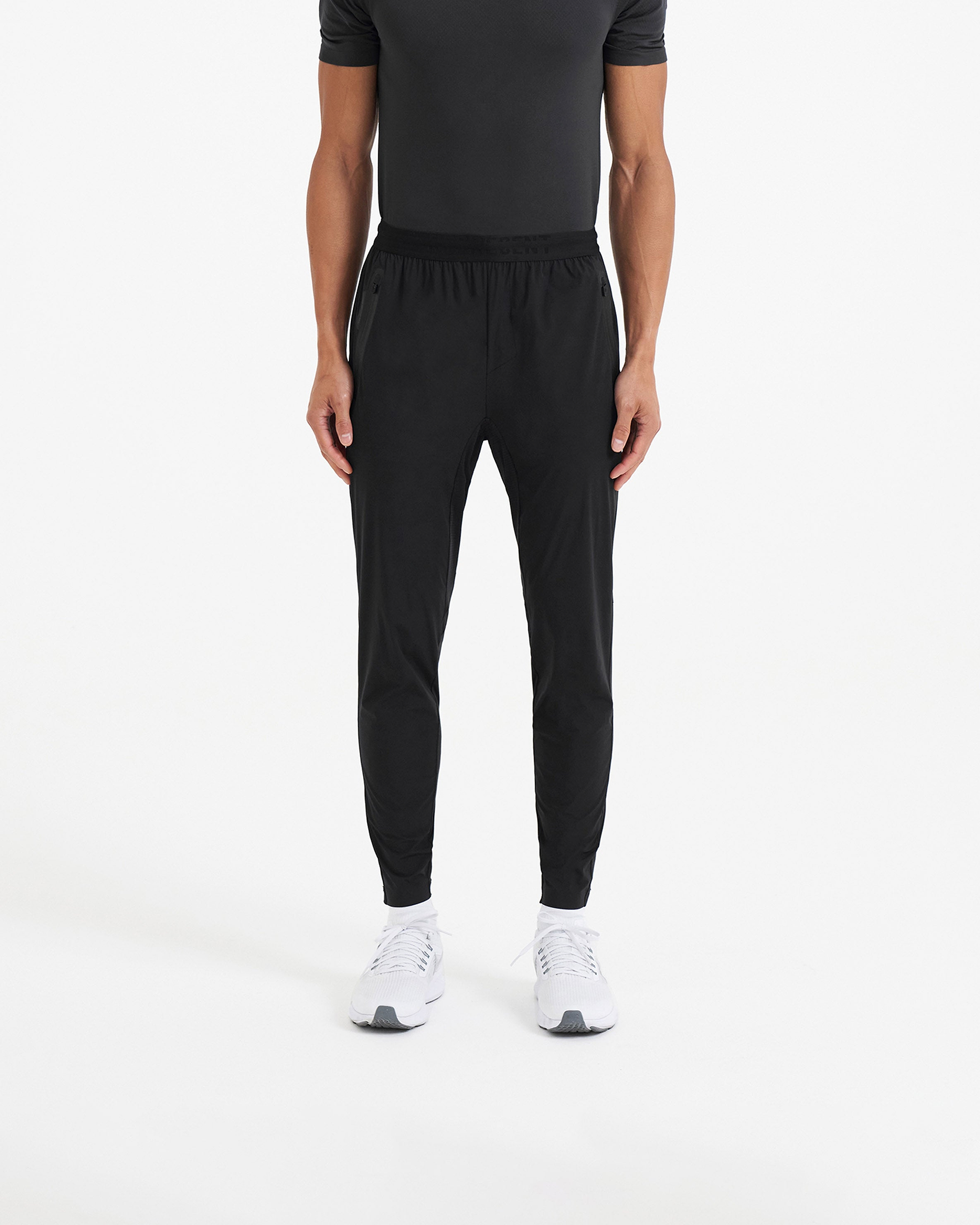 Back product image of mens black joggers on a plain white background | 247 Active Jogger in Black | Running pants with 4-way stretch and zip pockets | 247 Pants | Represent Clo
