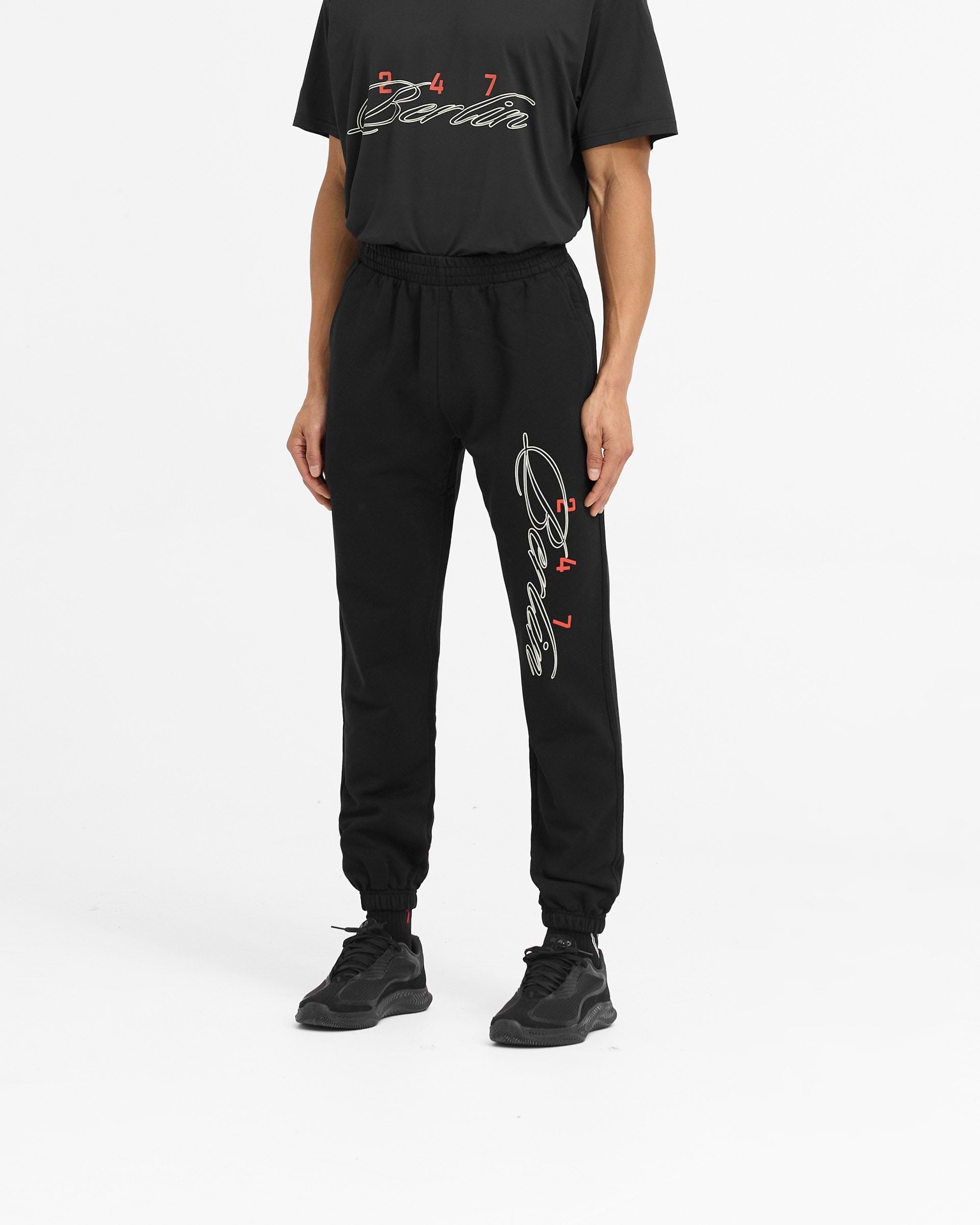 Back product image of mens black sweatpants on a plain white background | 247 Berlin Sweatpant in Black | Sweatpants with elasticated cuffs and drawcord waistband | 247 Pants | Represent Clo