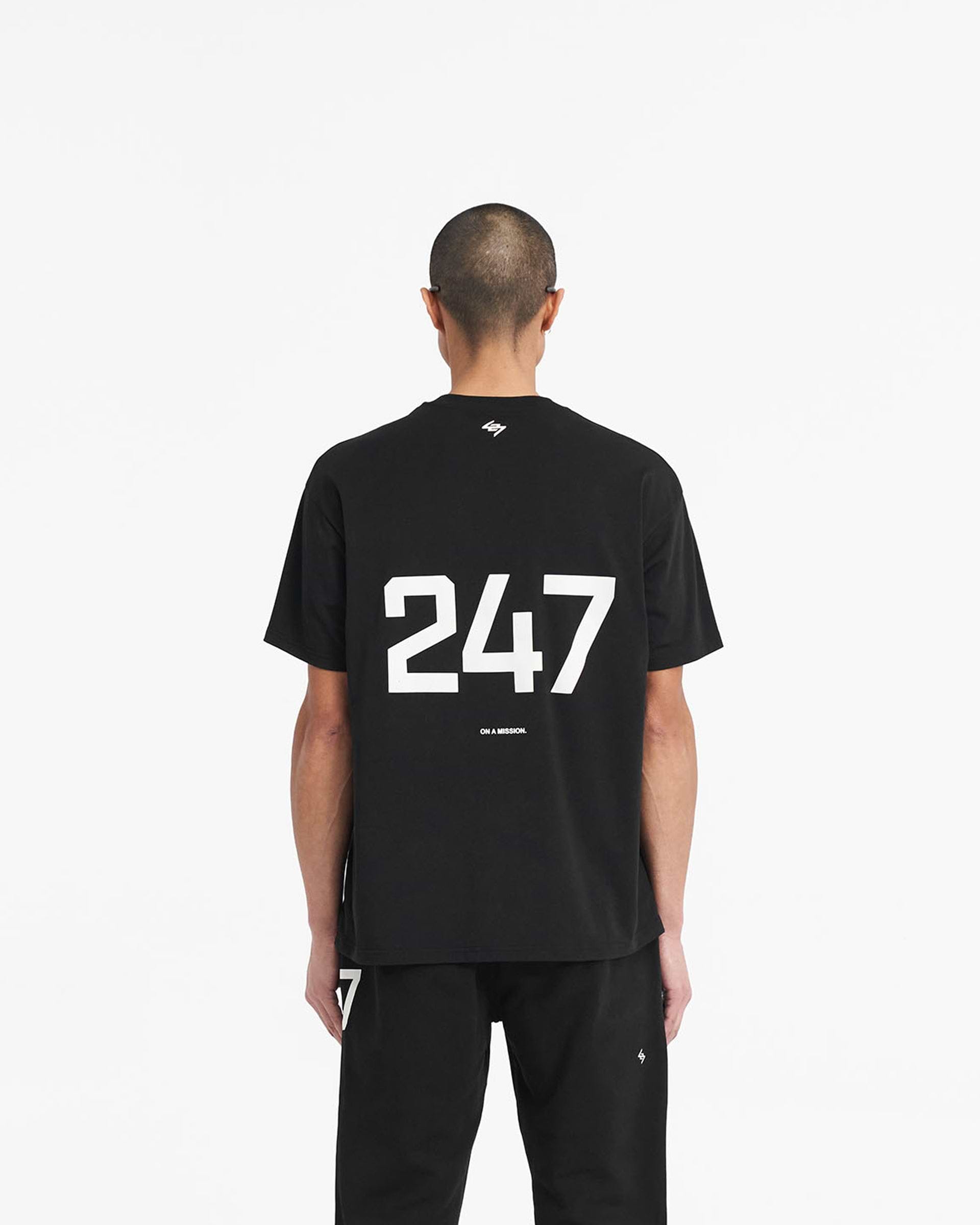 Man wearing an oversized black t-shirt on a plain white background | 247 Oversized T-Shirt in Jet Black | Oversized gym top with breathable antibacterial fabric | 247 T-Shirts | Represent Clo