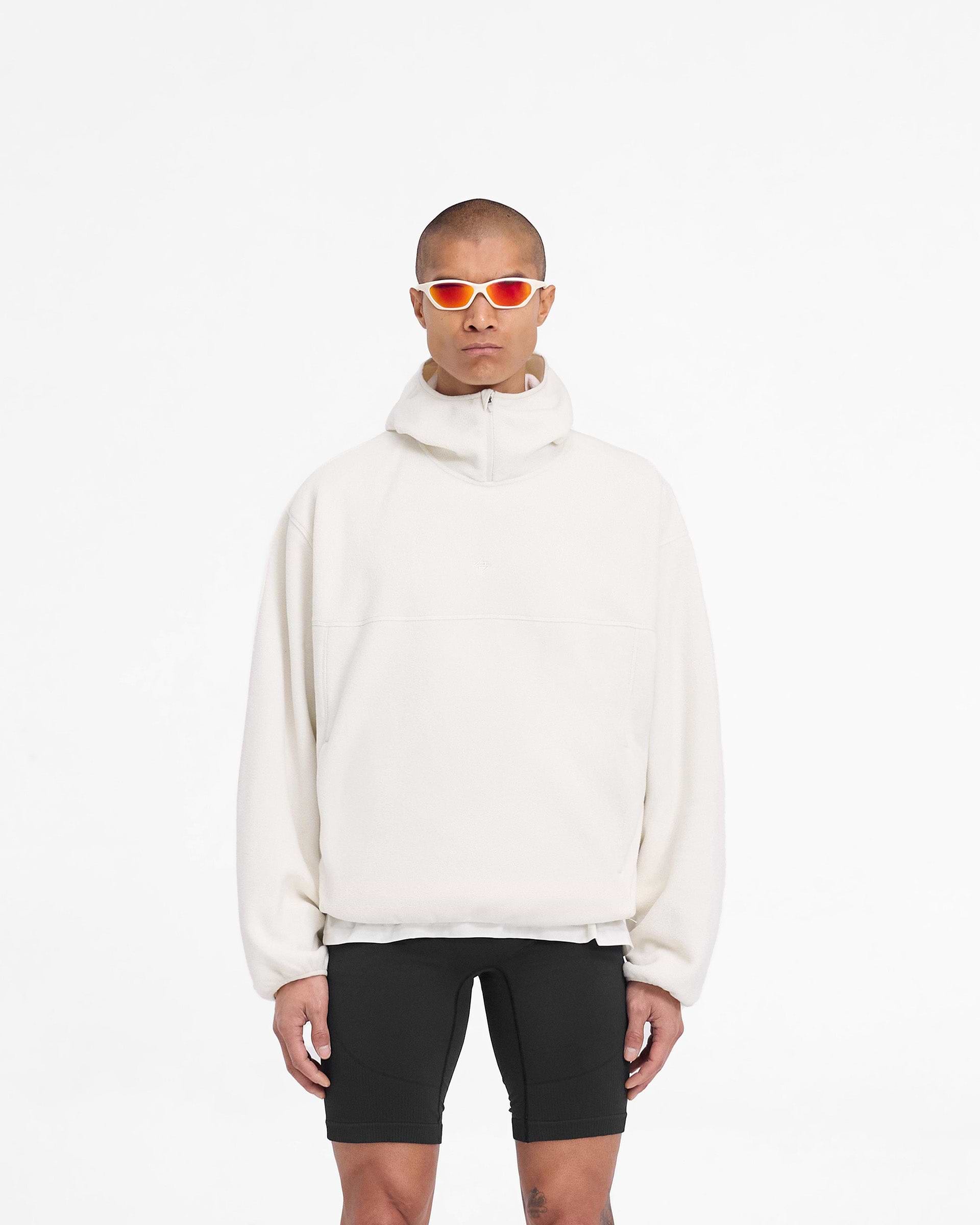 Man wearing an oversized fleece hoodie in white on a plain white background | 247 Fleece Hoodie in Papyrus | Oversized boxy fit hoodie with zip to high chin guard | 247 Hoodies | Represent Clo