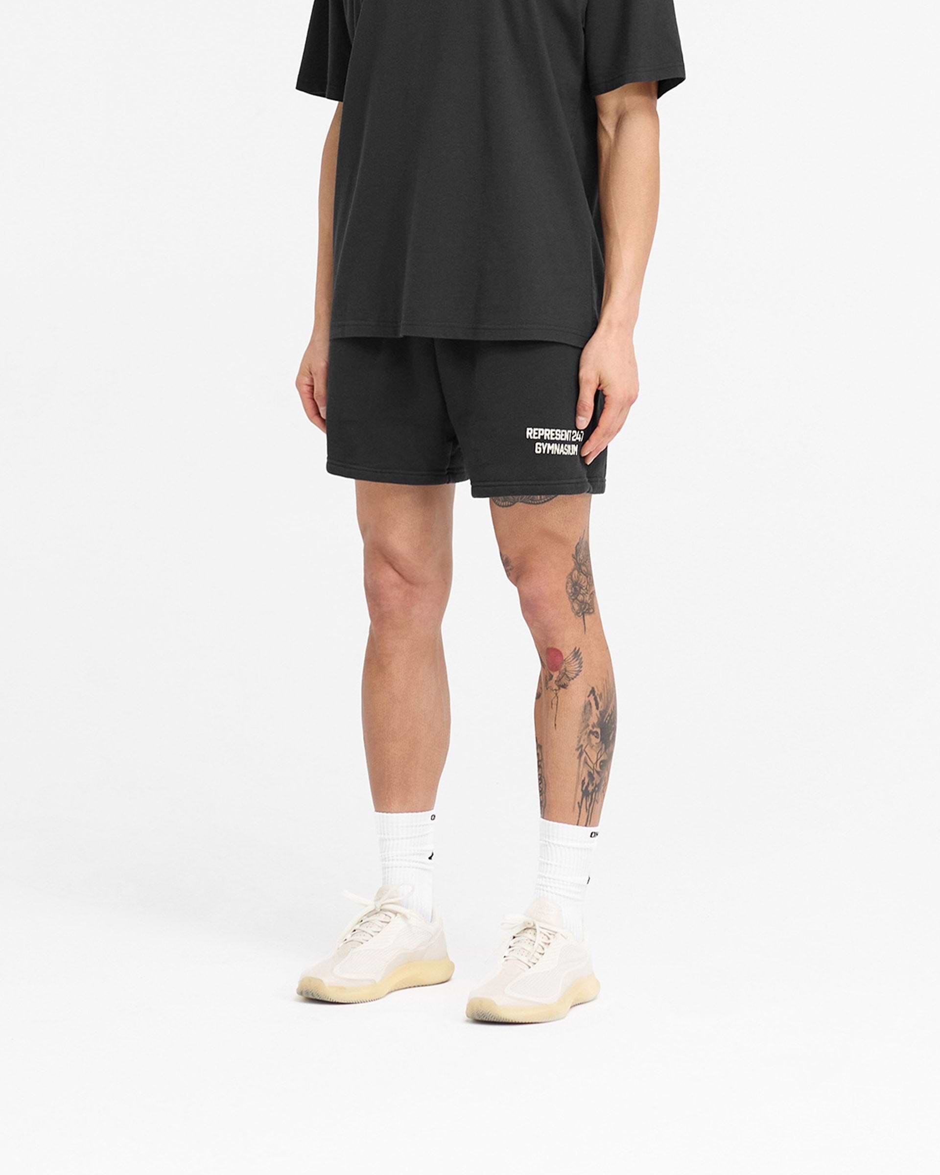 Back product image of mens black shorts on a plain white background | 247 Gymnasium Jersey Shorts in Off Black | Fleece cotton boxy shorts with print | 247 Shorts | Represent Clo