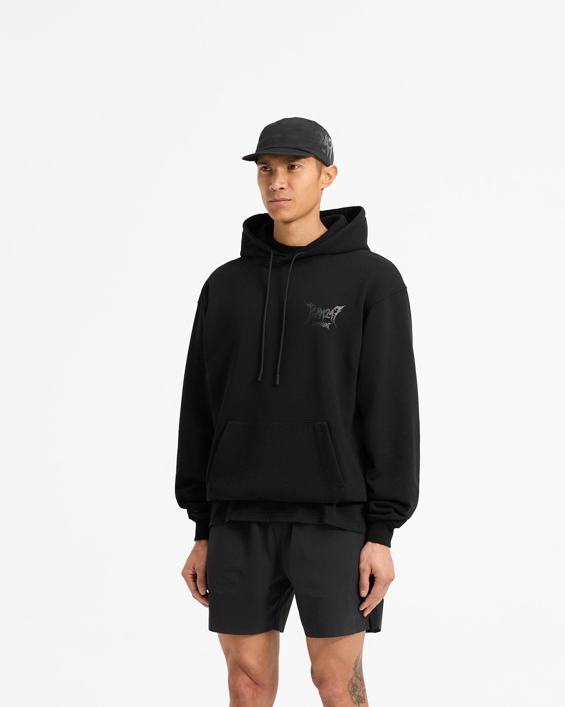 Man wearing an oversized black hoodie on a plain white background | Team 247 X END Oversized Hoodie in Jet Black | Hoodie with ribbed cuffs and co-branded graphics | 247 Hoodies | Represent Clo