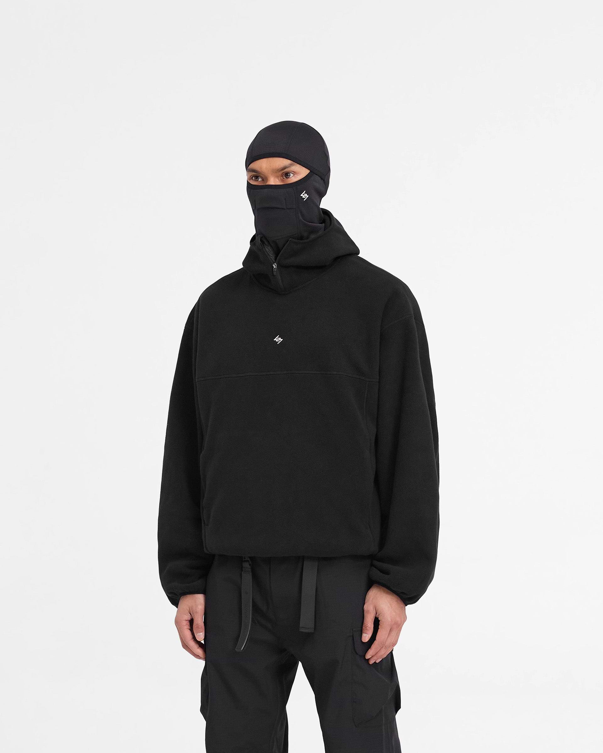 Man wearing a black fleece hoodie on a plain white background | 247 Fleece Hoodie in Black | Oversized fleece hoodie with zip pockets | 247 Hoodies | Represent Clo