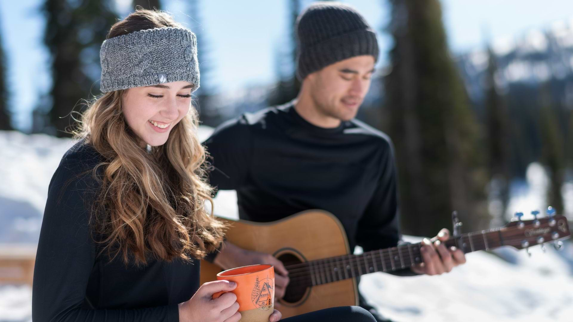 Couple in the mountains wearing Heat Holders thermal apparel and accessories