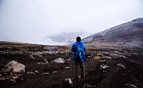 A man overlooking the mountains and clouds