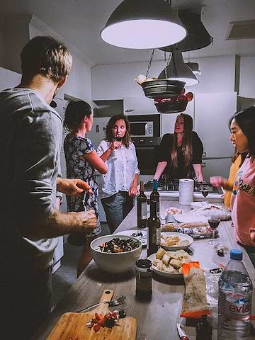 People in a kitchen standing and chatting