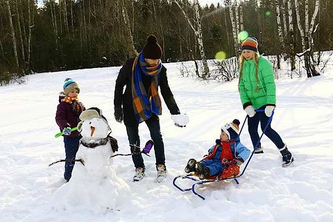 Family playing together in the snow