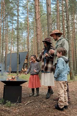 Family by the fire pit toasting marshmallows