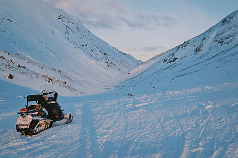 Snowmobile sits in a snowy vally. Heat Holders­® Base Layers