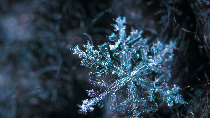 Close up of crystalline snowflake. Heat Holders® Thermal Outerwear. 