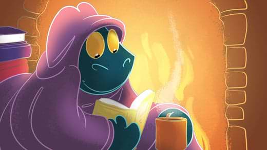 Toestie the Dragon, cuddled up in Heat Holders® reads a book by the fire, holding a cup of hot cocoa. | Heat Holders® Thermal Wear | Heat Holders® at Home |