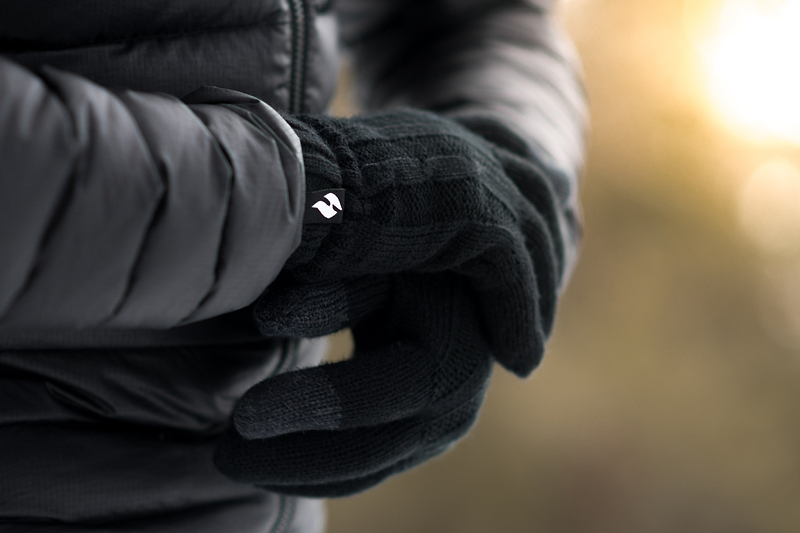 Close up of man's hands wearing Heat Holders® thermal gloves.
