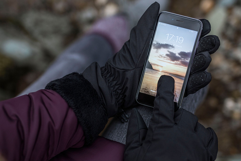 Person holding a cell phone, wearing Heat Holders® Touch Screen glove