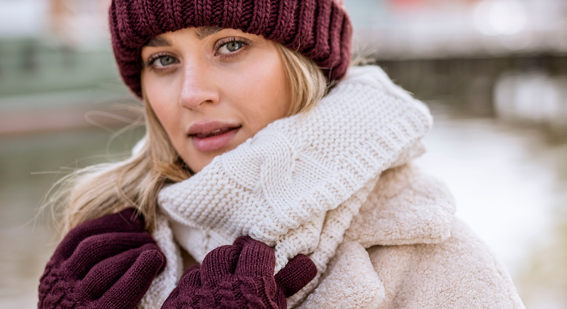 Woman wearing a beanie, winter coat, and gloves