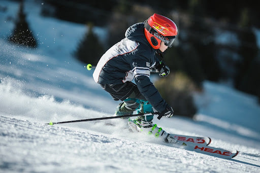 Boy skiing down a hill