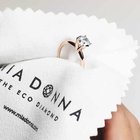 engagement ring getting cleaned with microfiber cloth