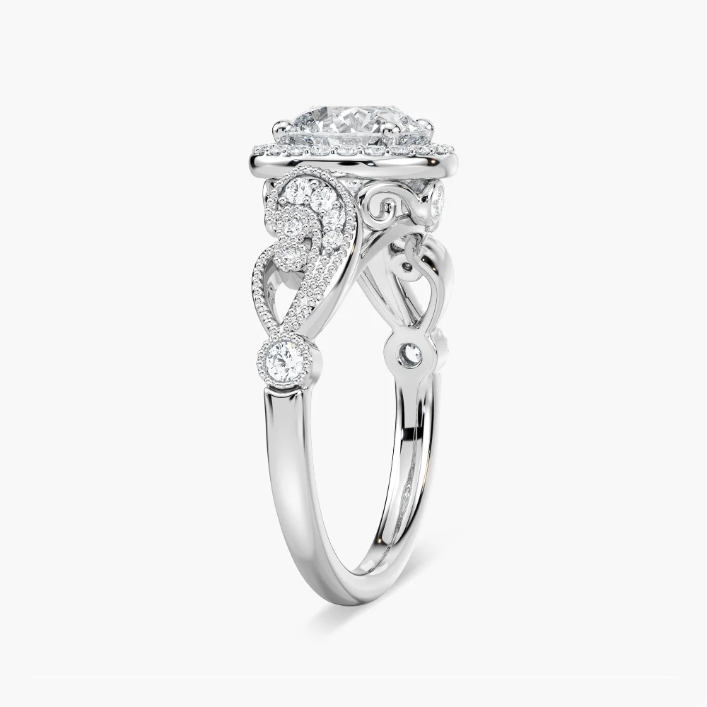 Shown with 1ct Round Cut Lab Grown Diamond in 14k White Gold|Vintage style diamond accented halo engagement ring with 1ct round cut lab created diamond with milgrain and filigree detailing in two tone 14k white gold