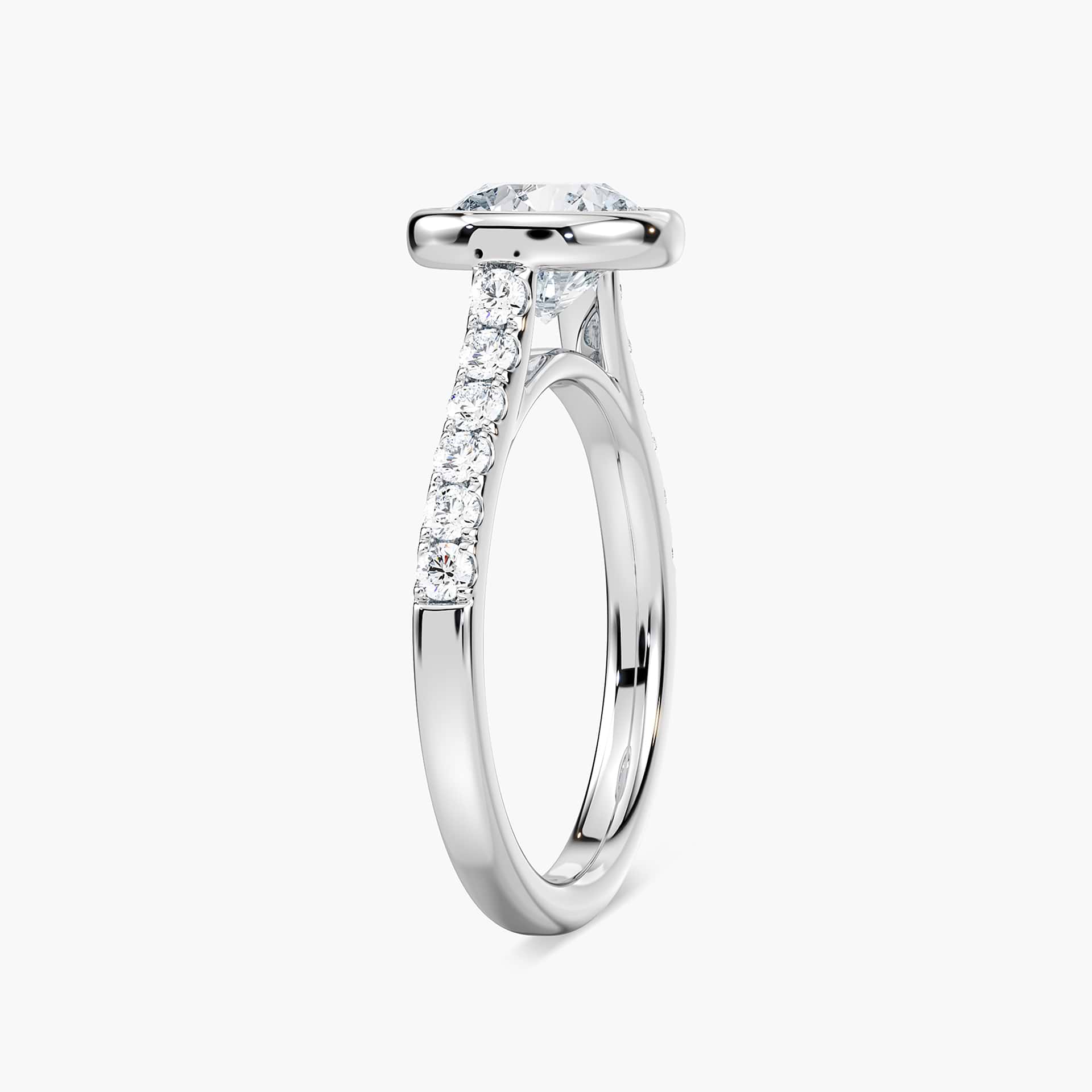 Shown with a bezel set 1.0ct Round cut Lab-Grown Diamond with accenting stones on the band in recycled 14K white gold | stackable engagement ring Shown with a bezel set 1.0ct Round cut Lab-Grown Diamond with accenting stones on the band in recycled 14K white gold