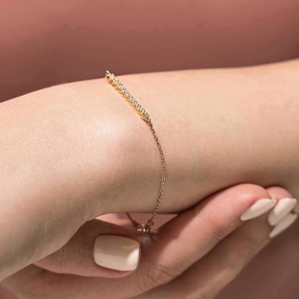 Diamond Bar Bracelet is set with 0.15ctw Lab-Grown Diamonds in a straight bar setting shown in recycled 14k yellow gold.