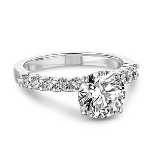 diamond accented ring with a round cut lab grown diamond center stone